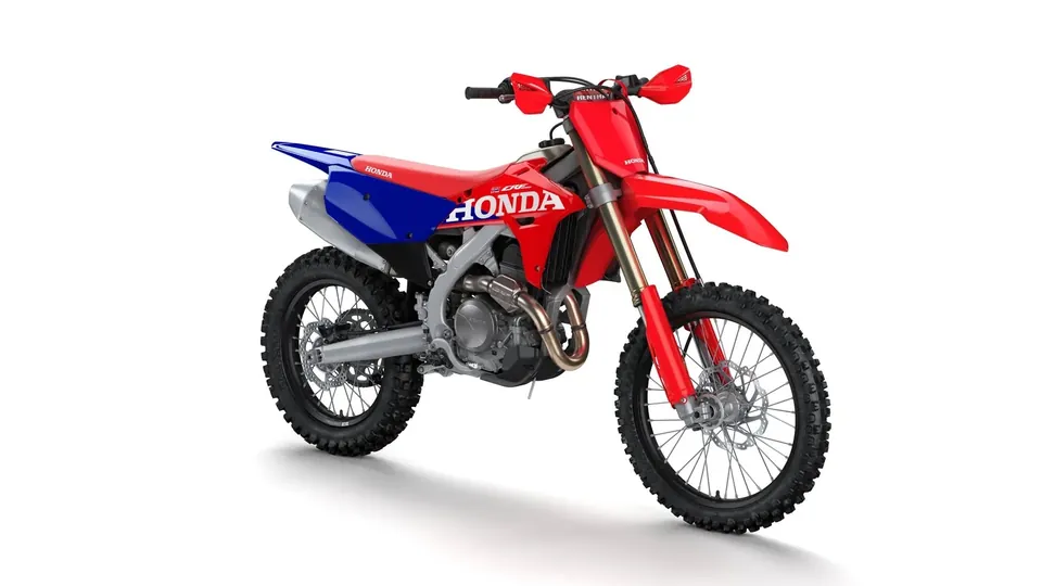 Honda CRF450RX from a front angle with hand guards on the handlebar